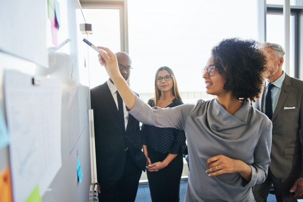 Diverse team of colleagues brainstorming together in a modern office